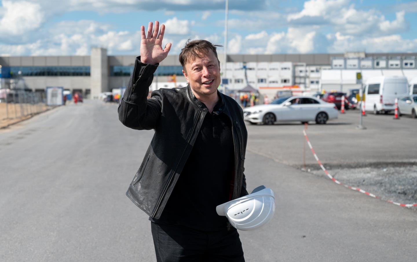 17 May 2021, Brandenburg, Grünheide: Elon Musk, Tesla CEO, stands on the construction site of the Tesla factory and waves.