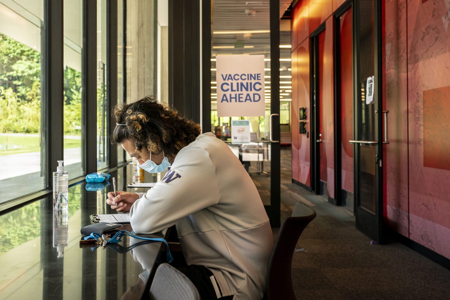 Student wearing mask studying at desk outside of clinic