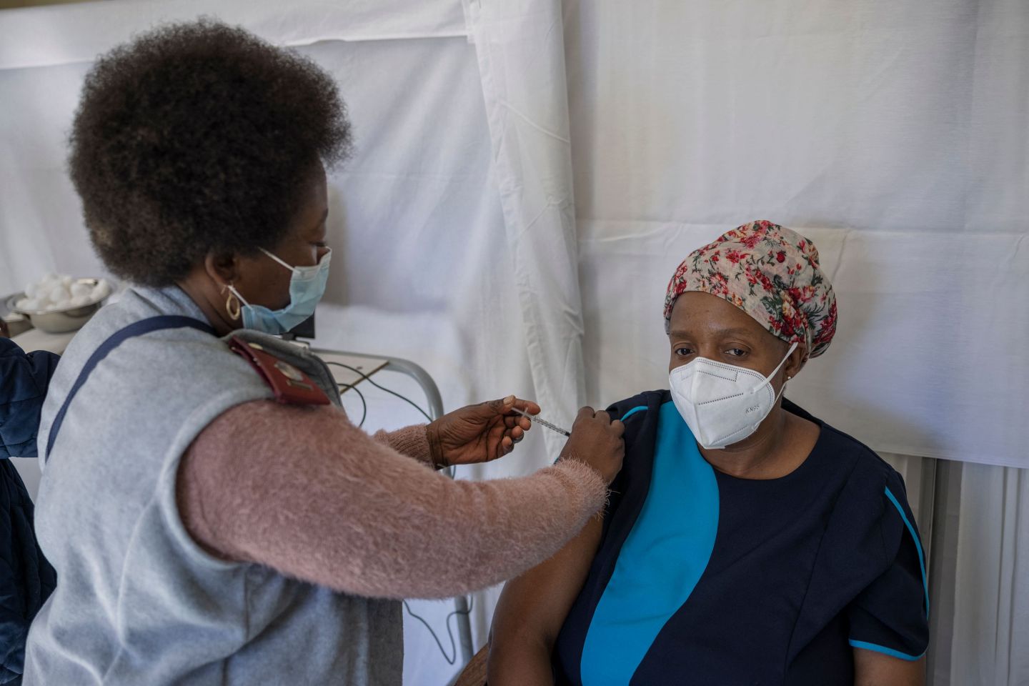 An health care worker administers a jab containing Pfizer vaccine on a caregiver of the SAVF Evanna Tehuis old age home near Klerksdorp, South Africa, on May 19, 2021.
