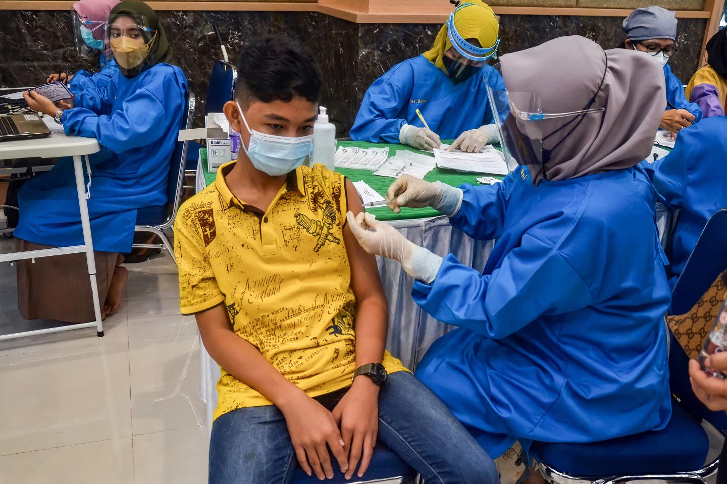 Countries eye booster shots as the delta variant evades less effective COVID vaccines