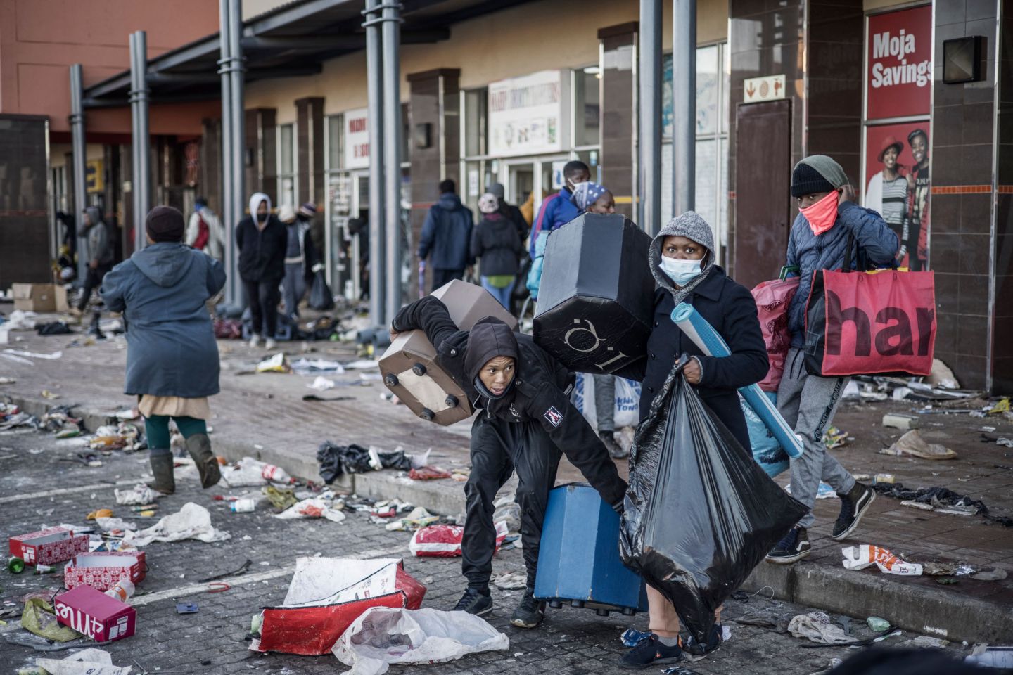 Looters take away few items left to grab in a vandalised mall in Vosloorus, on July 14, 2021. The raging unrest first erupted last Friday after former president Jacob Zuma started serving a 15-month term for contempt, having snubbed a probe into the corruption that stained his nine years in power.