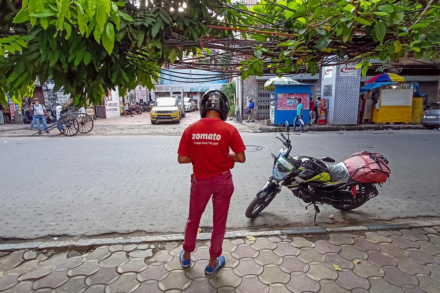 A Zomato food delivery partner is seen on a road in Kolkata, India on July 14, 2021.