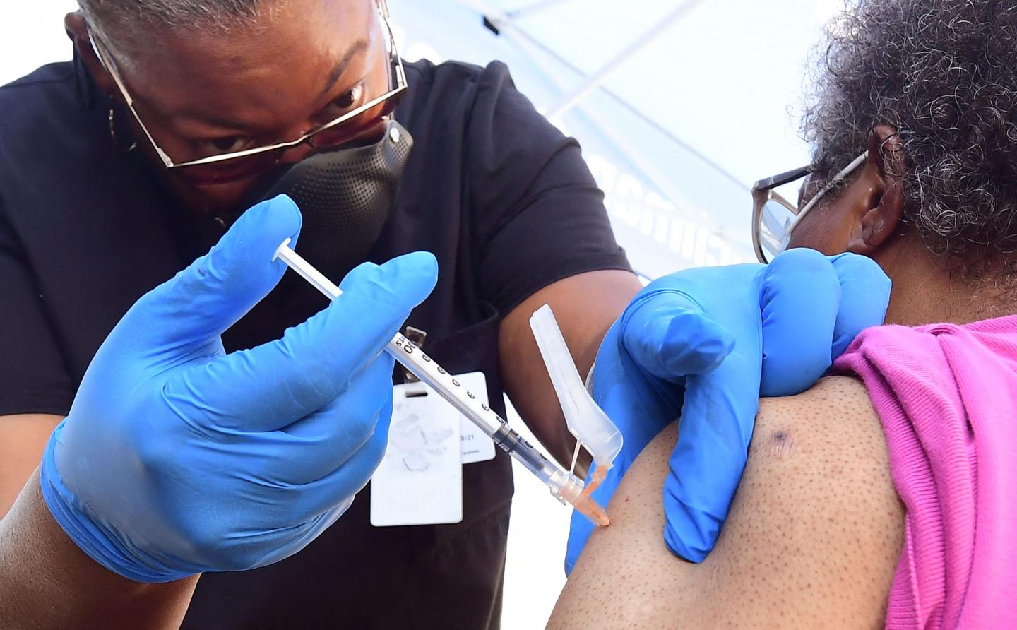 Medical professional giving Covid-19 vaccine