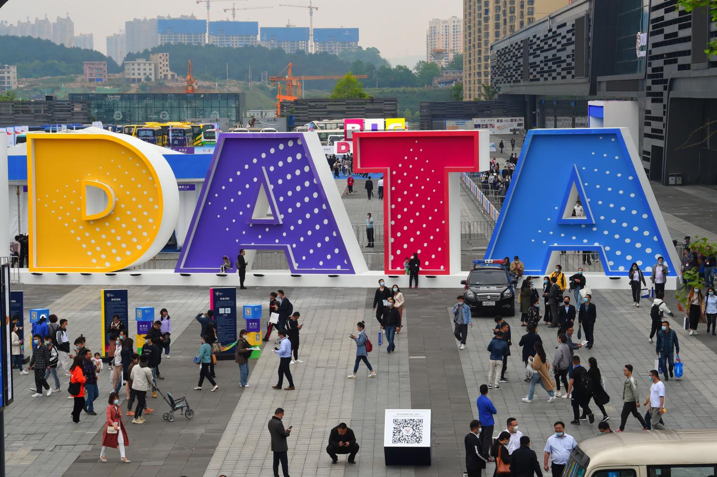 People walk past a sign during China International Big Data Industry Expo at Guiyang International Conference and Exhibition Center on May 26, 2021 in Guiyang, Guizhou Province of China.