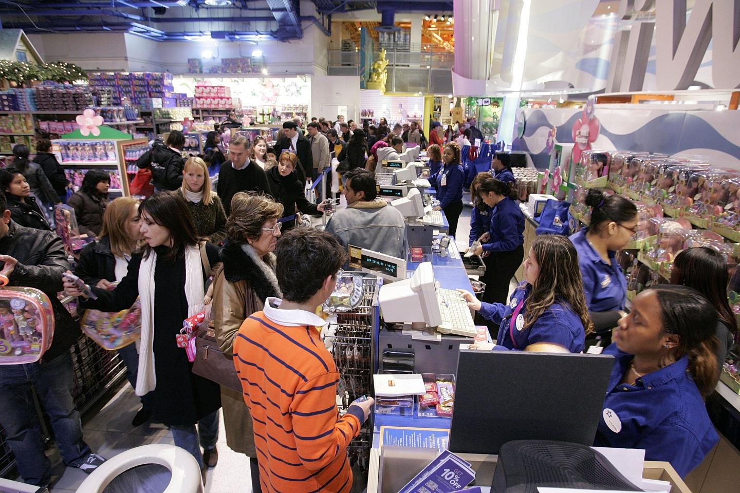 Black Friday shoppers at a toy store in New York City in 2006. “We are not the same people now as we were before the pandemic,” writes J.B. MacKinnon, “and to be asked to put those changes behind us and return to full-throttle consumption is insulting.”