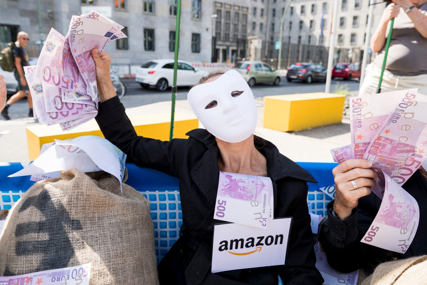 Activists of Campact and of the network for Tax equity dressed as te CEOs of big corporations (BASF, Amazon, Apple) protest in front of the Finance Ministry in Berlin, Germany on May 24, 2018.