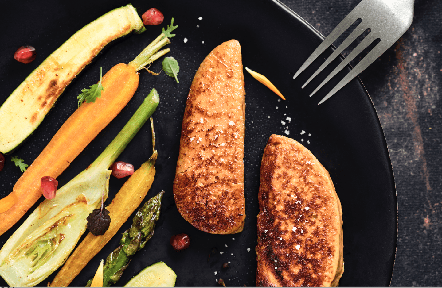 Photo of slabs of lab-grown foie gras from French startup Gourmey being pan-fried.