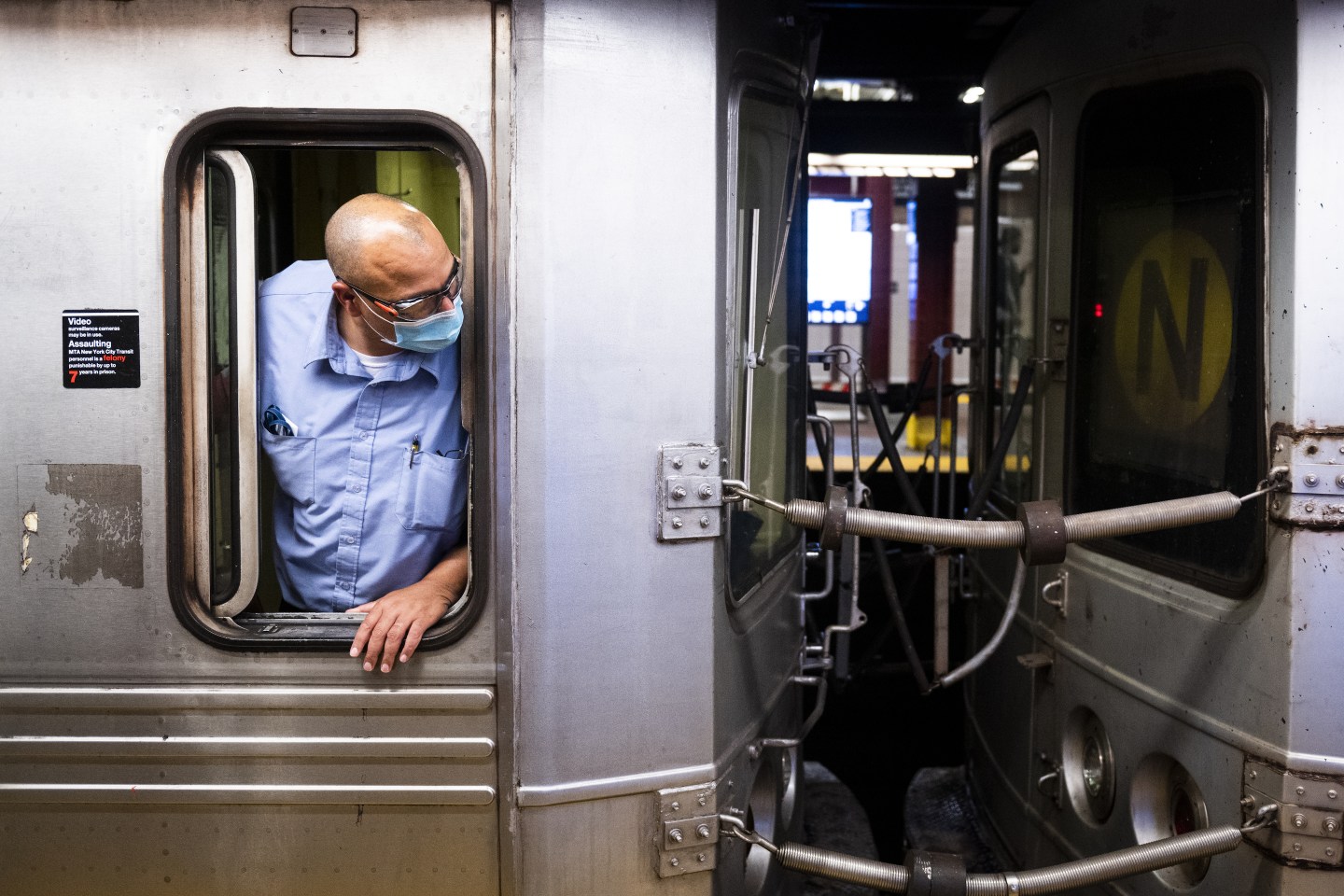 A conductor checks for commuters entering a train before departing a subway station in New York, U.S., on Friday, July 2, 2021. New York&#8217;s Metropolitan Transportation Authority needs more riders to help support a record $51.5 billion capital plan to expand service throughout the New York City region and modernize its infrastructure. Photographer: Mark Kauzlarich/Bloomberg