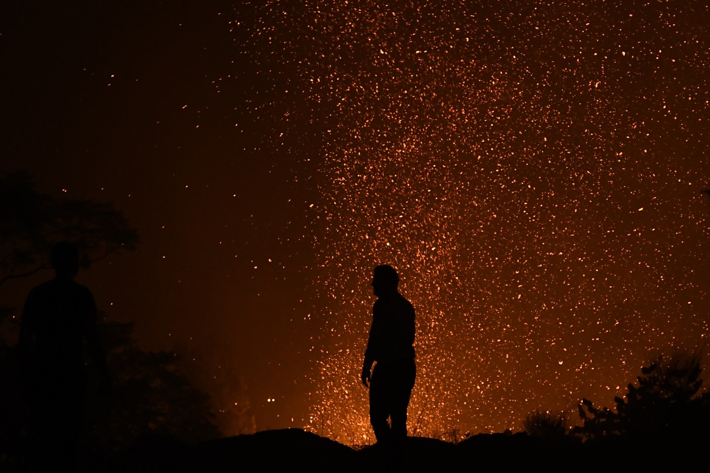Flames are seen at forestland after a forest fire at the area of Varybobi, northeastern suburb of Athens, Greece on August 03, 2021.