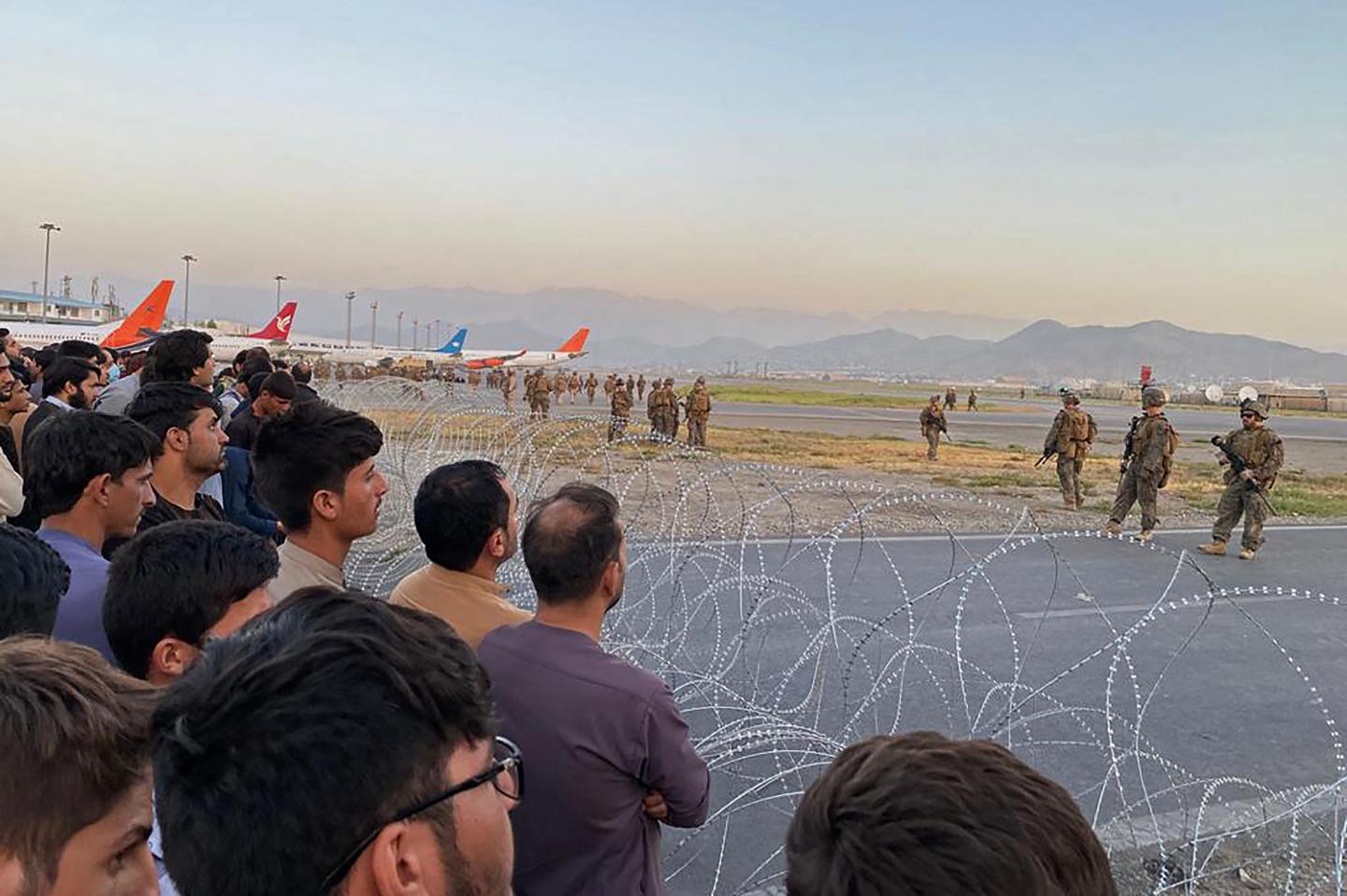 Americans and other foreigners frantically evacuate Kabul as the Taliban enter the city