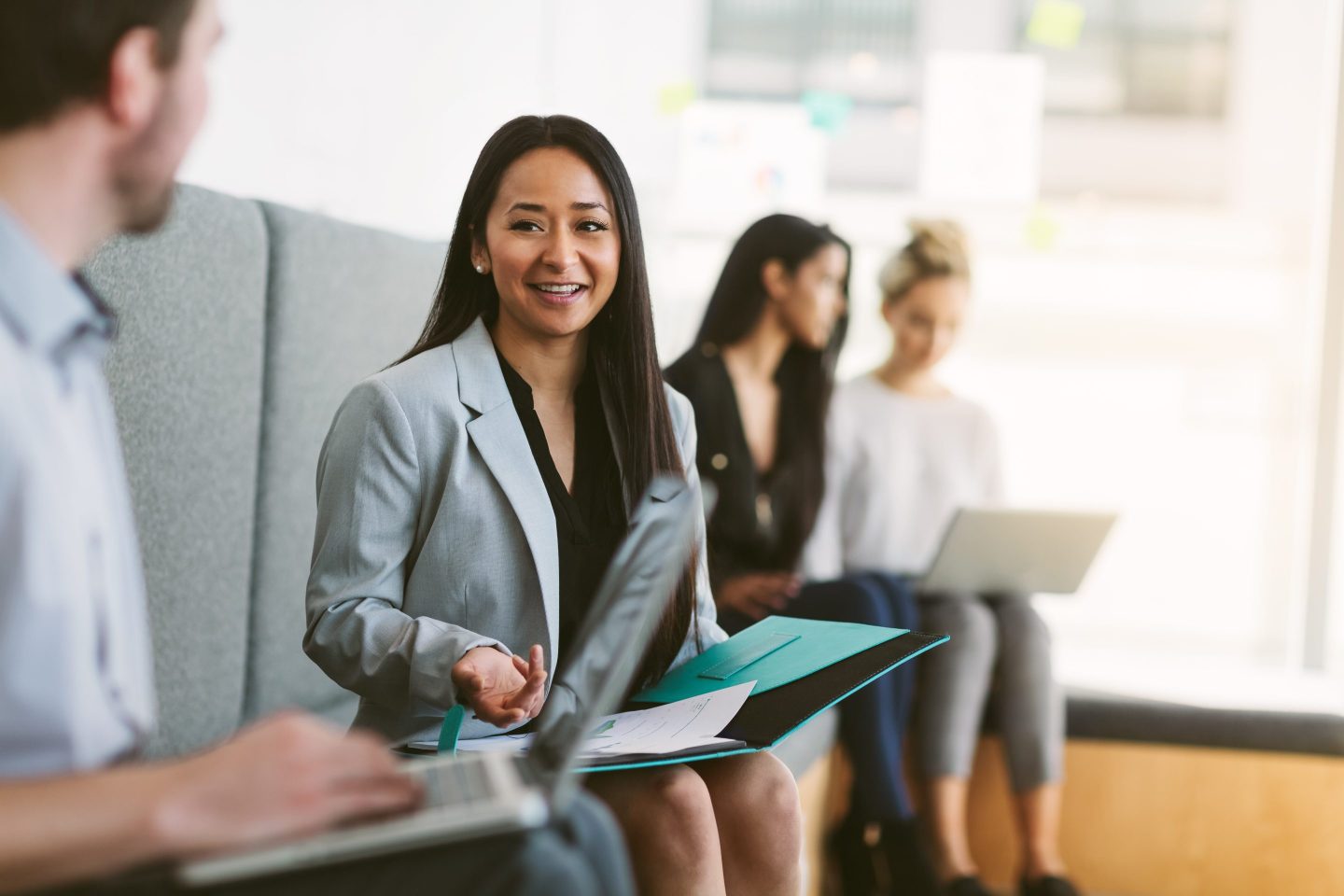Woman discuses a work plan with colleagues.