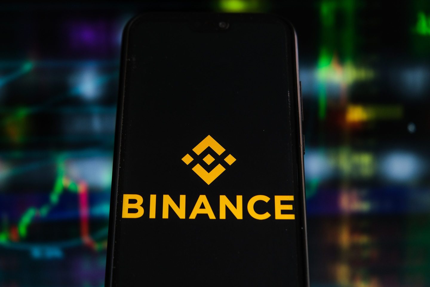 POLAND &#8211; 2021/07/12: In this photo illustration a Binance logo seen displayed on a smartphone with stock market percentages in the background. (Photo Illustration by Omar Marques/SOPA Images/LightRocket via Getty Images)