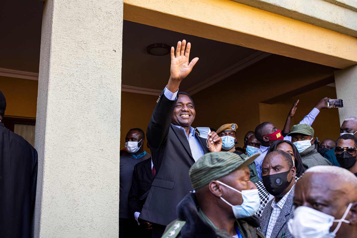 President elect Hakainde Hichilema (C) waves at supporters after a press briefing at his residence in Lusaka, on August 16, 2021.