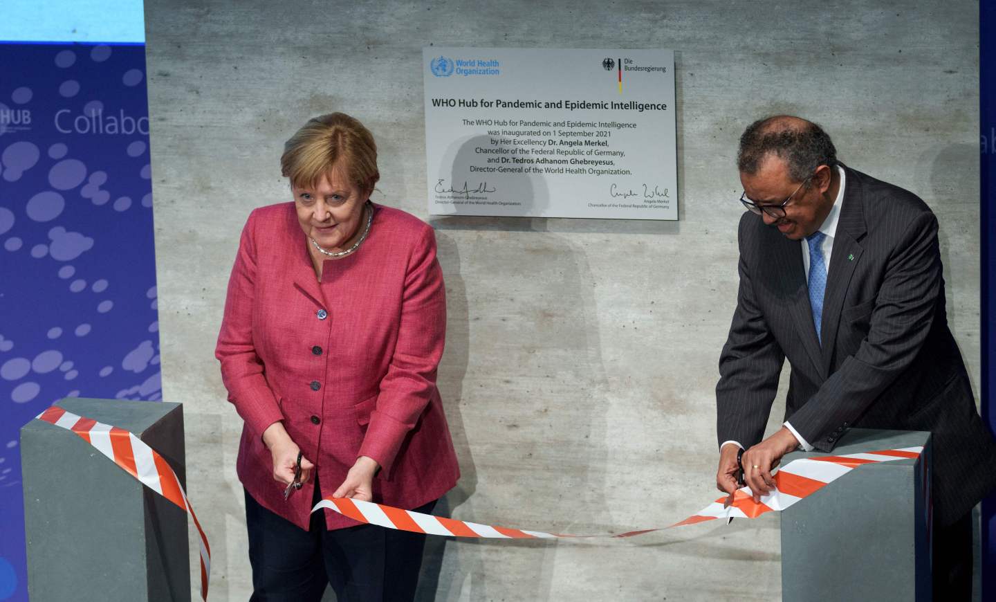 Tedros Adhanom Ghebreyesus (R), Director-General of the World Health Organization (WHO) and German Health Minister Jens Spahn and German Chancellor Angela Merkel cut the ribbon during the inauguration ceremony of the 'WHO Hub For Pandemic And Epidemic Intelligence' at the Langenbeck-Virchow building in Berlin, on September 1, 2021.