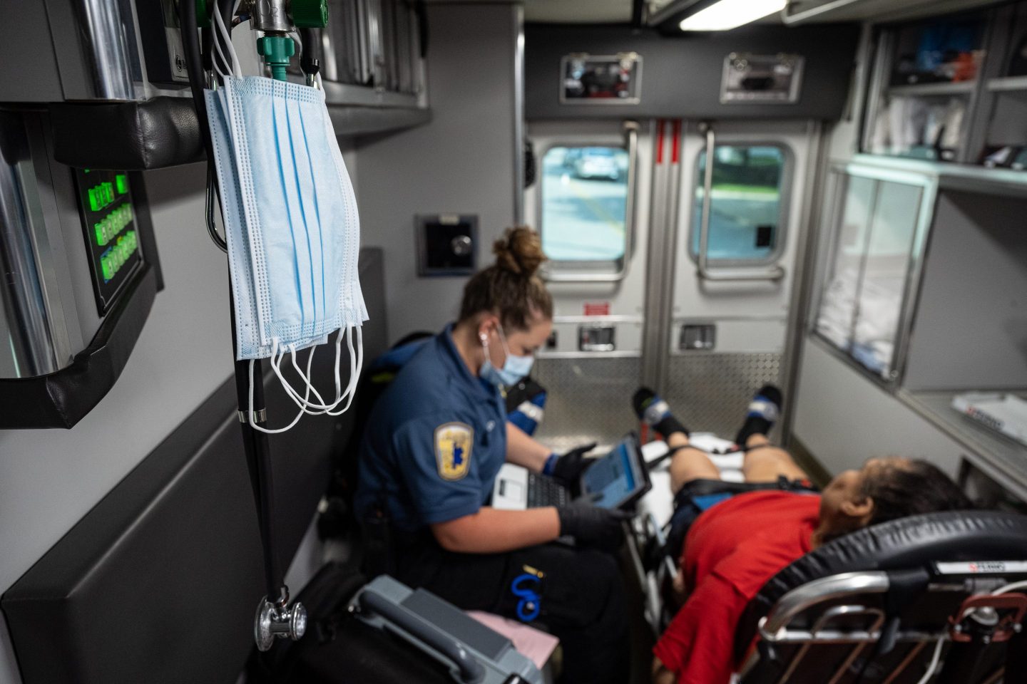 LOUISVILLE, KY &#8211; SEPTEMBER 13: Medical masks hang in the ambulance near a patient experiencing a COVID-19 emergency as a member of Louisville Metro Emergency Medical Services tends to the patient outside the patient&#8217;s home on September 13, 2021 in Louisville, Kentucky. Louisville Metro EMS is experiencing increasing numbers of patients with severe COVID-19 symptoms that require emergency transport to medical facilities. Kentucky Gov. Andy Beshear recently announced that the state surpassed 8,000 total COVID-19 related deaths. (Photo by Jon Cherry/Getty Images)