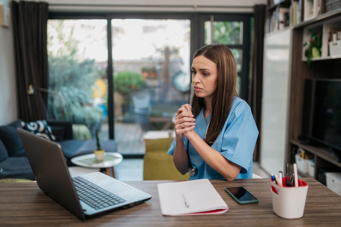 Woman looking stressed working from home