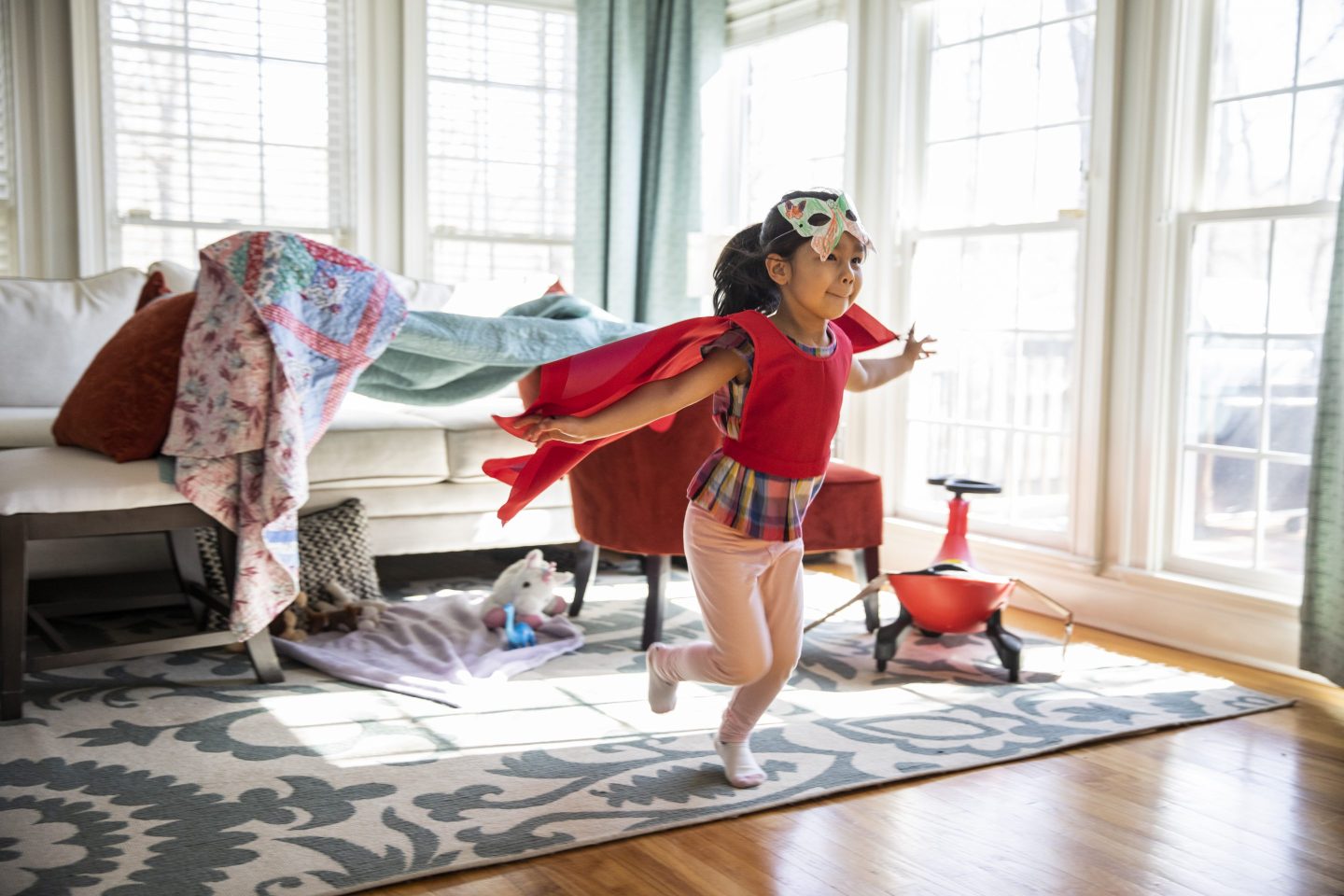 Child playing in a superhero costume
