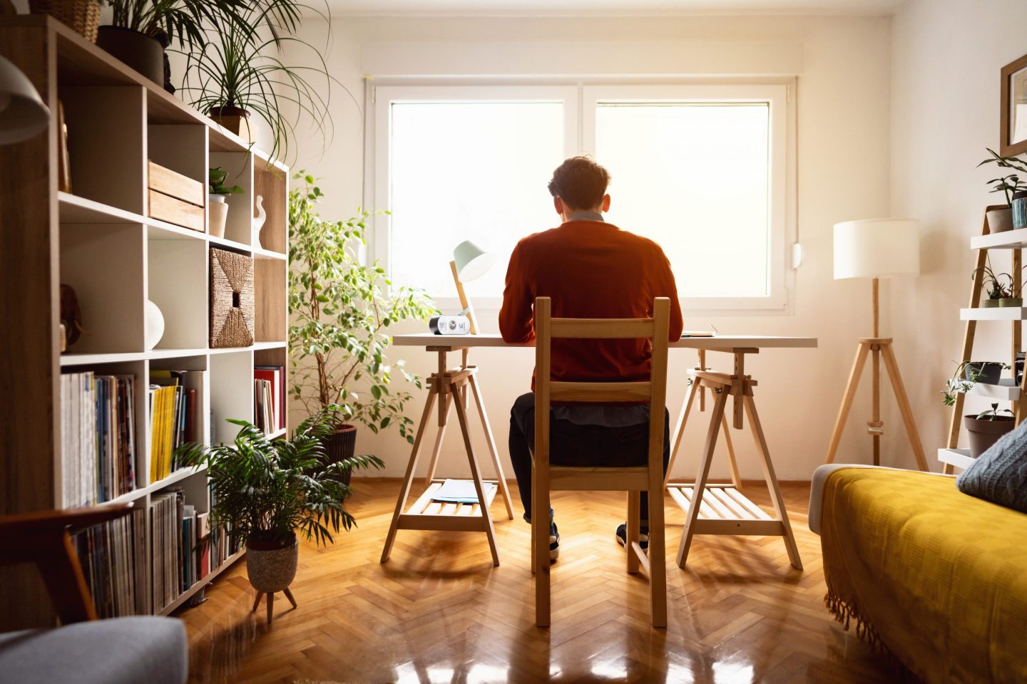 A young man sitting in his home office.