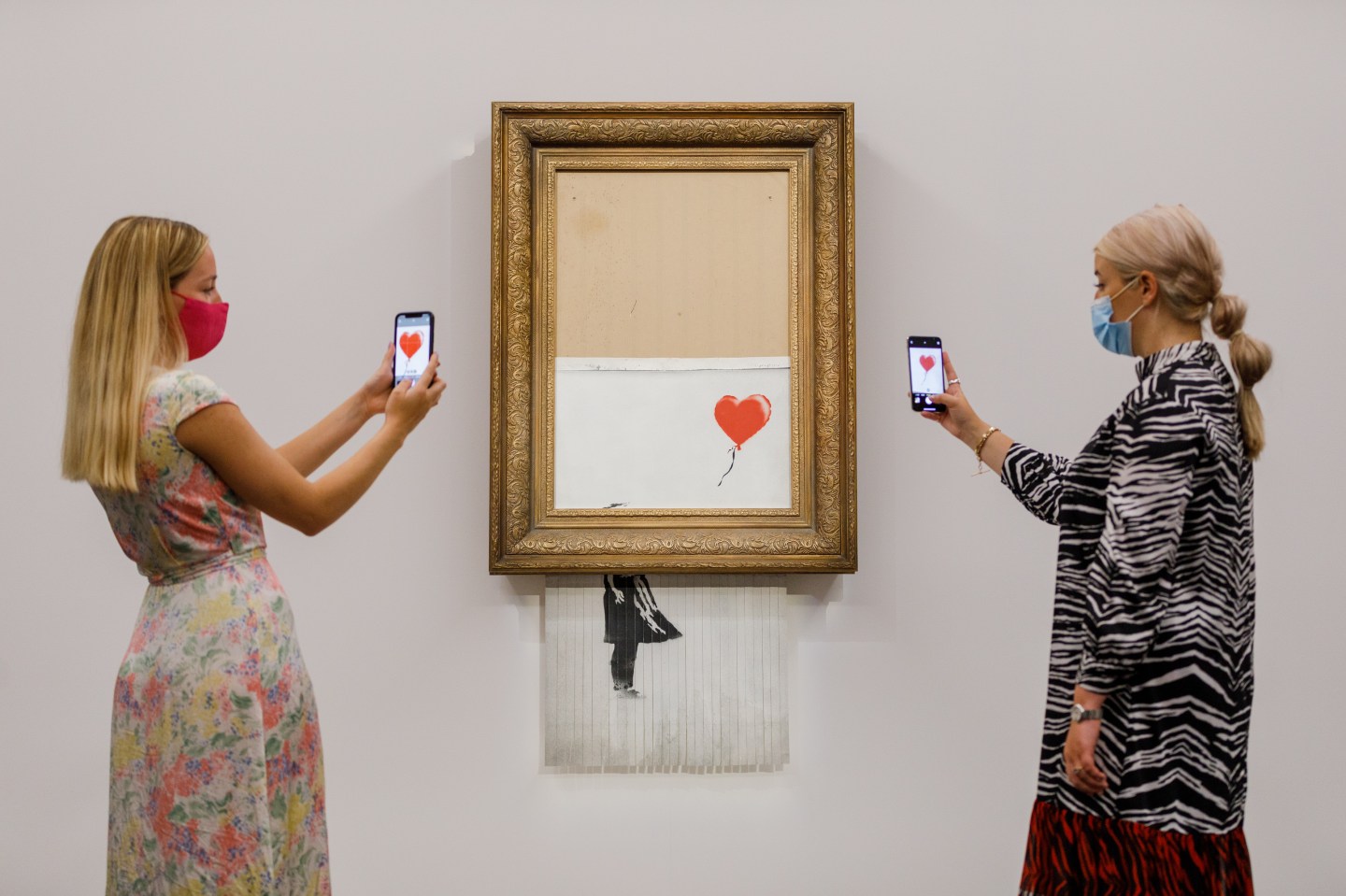 Banksy's "Love is in the Bin" (2018) is installed at Sotheby's on September 3, 2021 in London, England.