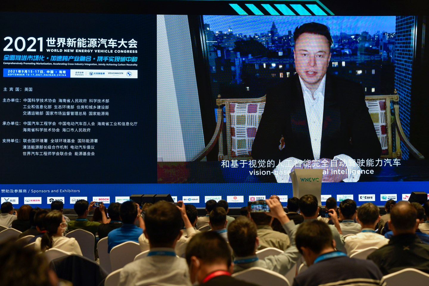 Tesla CEO Elon Musk speaks on-screen during the 2021 World New Energy Vehicle Congress on Sept. 17, 2021, in Haikou, Hainan province.