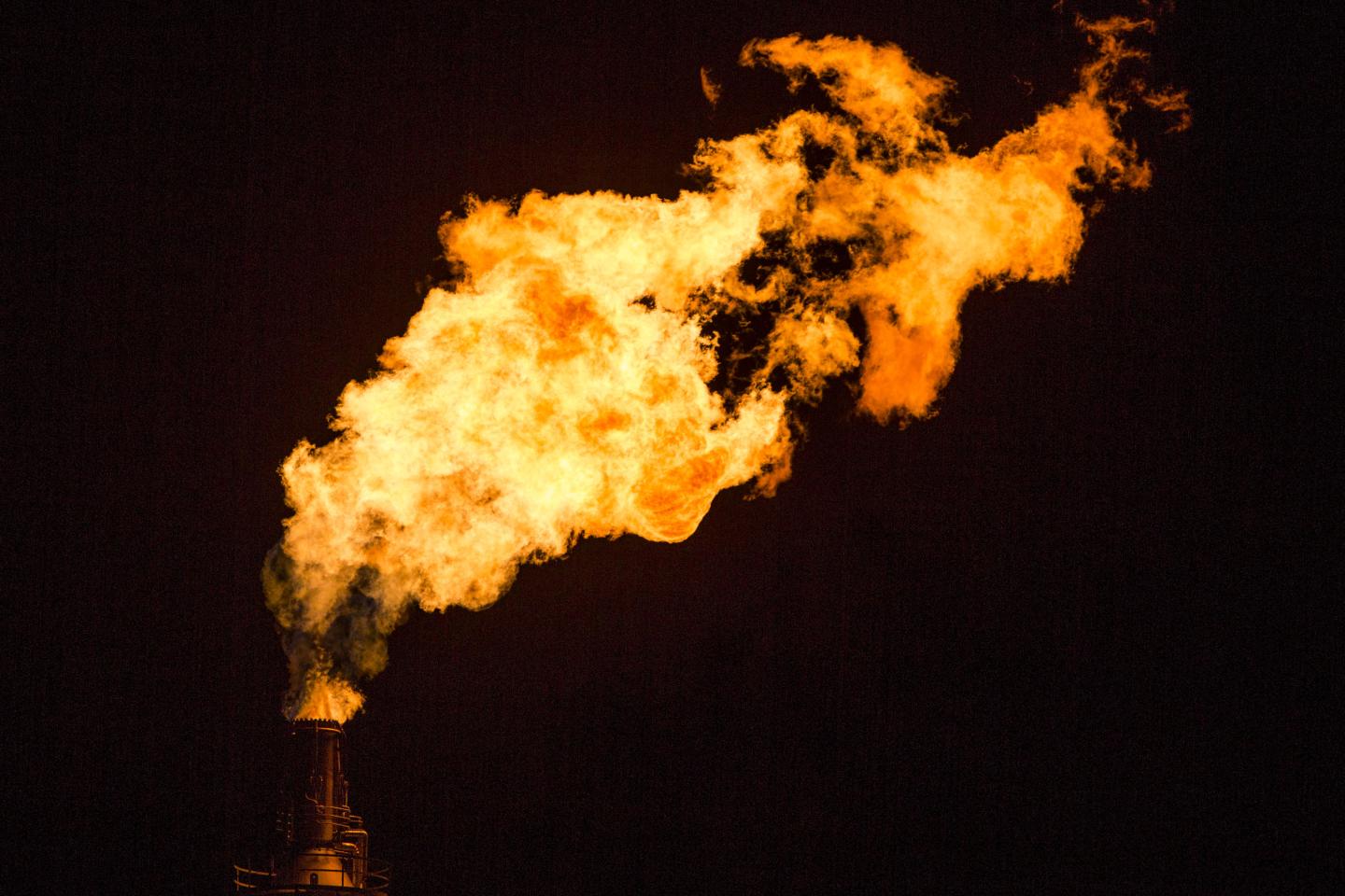 Flames shoot from a tower at the Exxon Mobil Corp. Torrance Refinery in Torrance, California, U.S., on Wednesday, March 16, 2016.