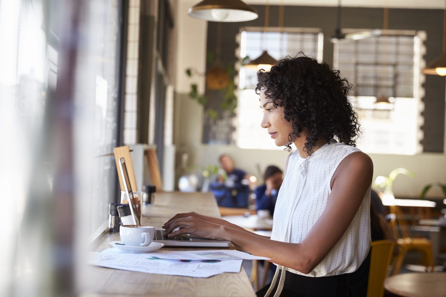 Woman By Window Working remotely