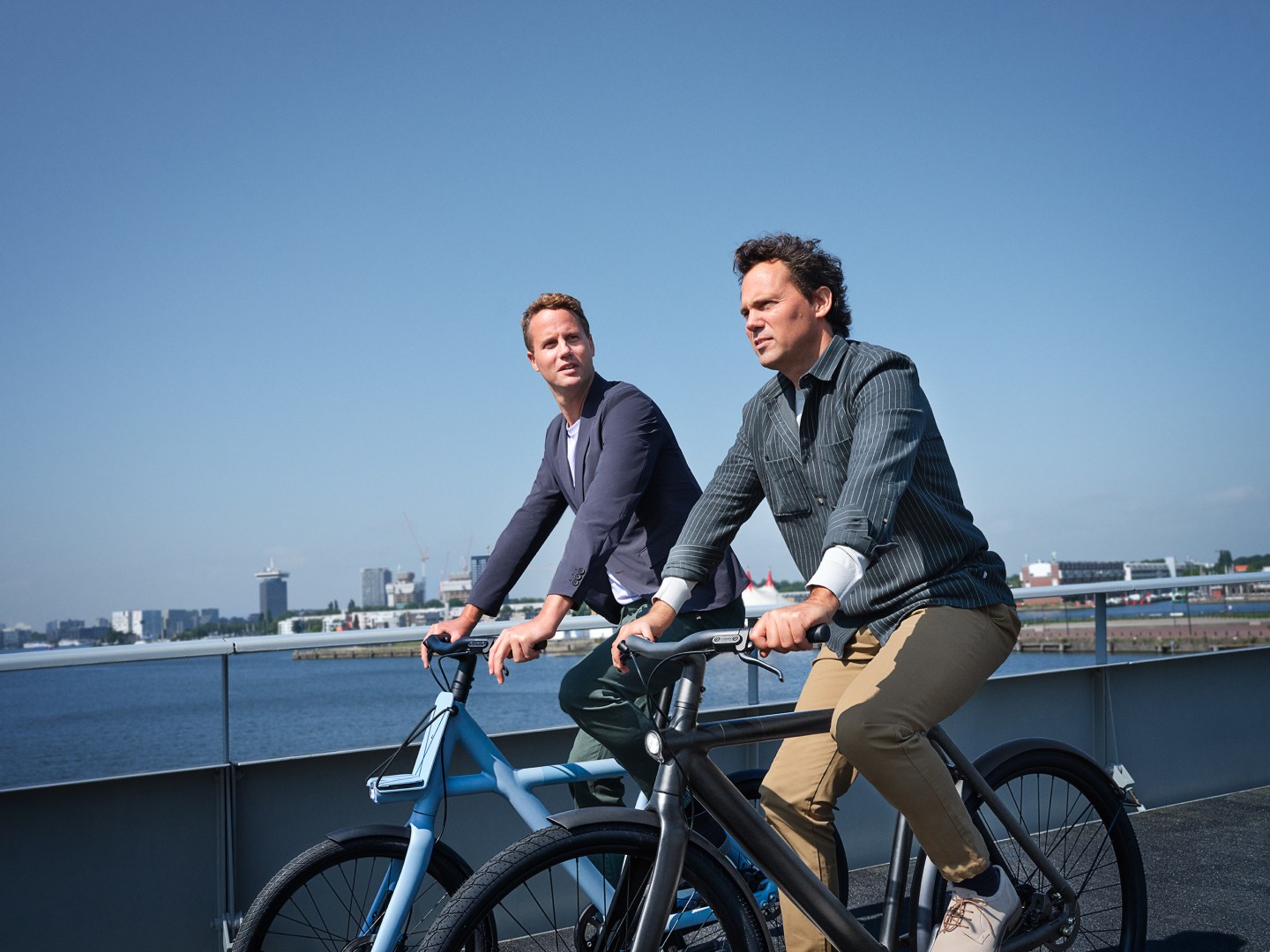 VanMoof co-founders Ties and Taco riding in Amsterdam on one of their e-bikes.