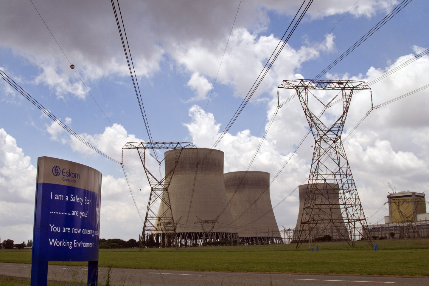 Electricity power lines and cooling towers are seen at Eskom Holdings Ltd.'s Kendal power station in Delmas, South Africa, on Monday, Dec. 6, 2010.