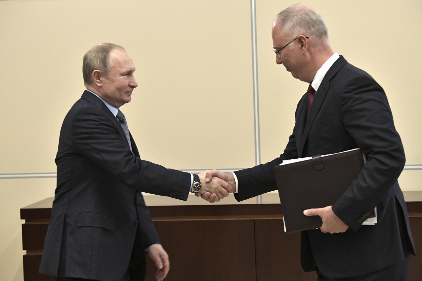 JANUARY 17, 2020: Russia's President Vladimir Putin (L) and Russian Direct Investment Fund CEO Kirill Dmitriev shake hands during a meeting at the Moscow Kremlin.