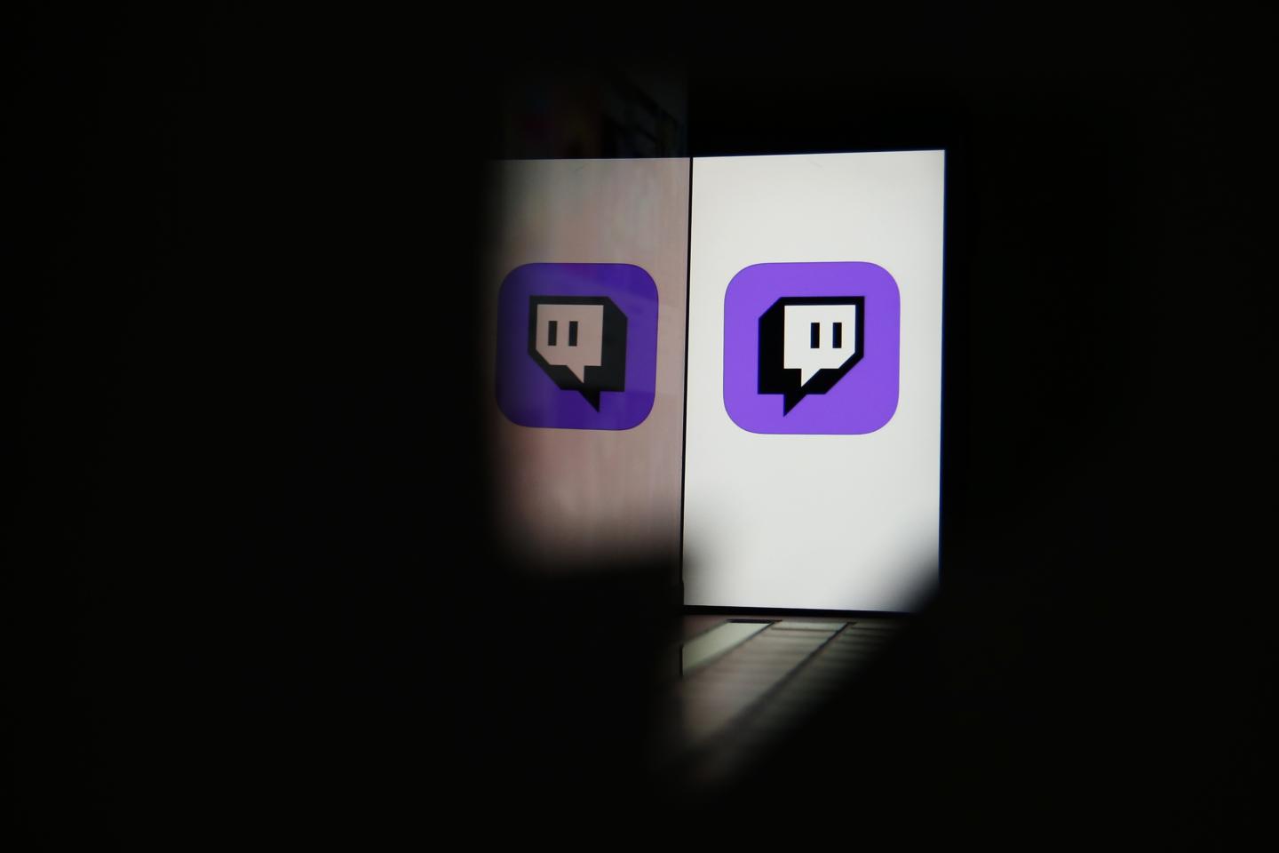 A smartphone displays a logo for the Twitch streaming app.