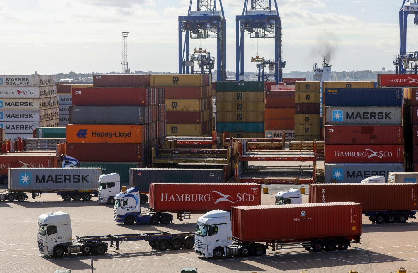 Trucks with shipping containers on the dockside at the Port of Felixstowe Ltd. in Felixstowe, U.K., on Friday, Oct. 15, 2021.