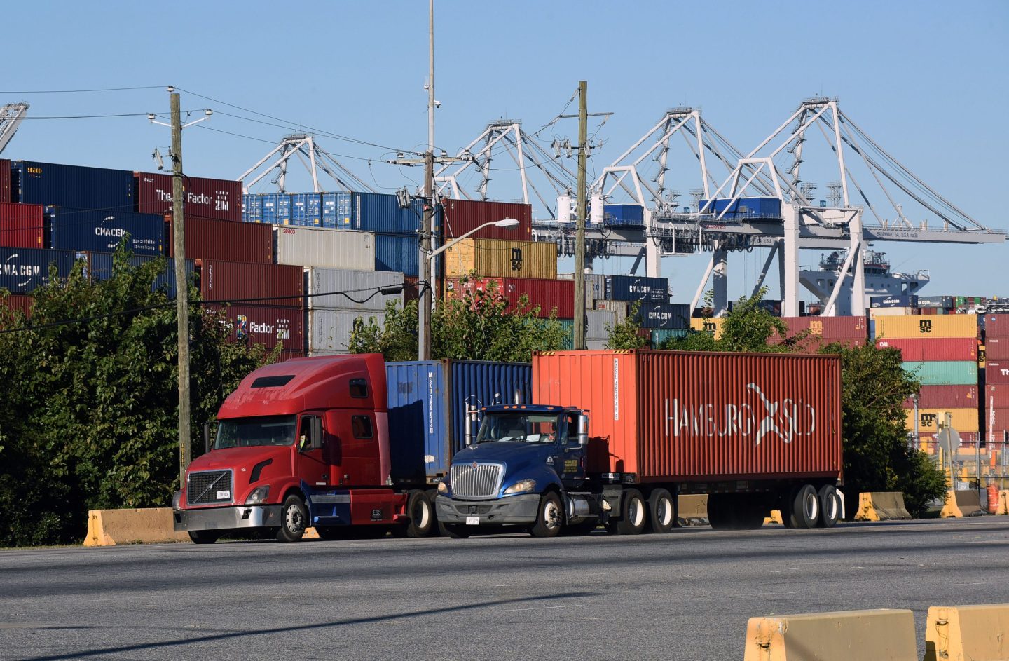 Trucks picking up shipping containers