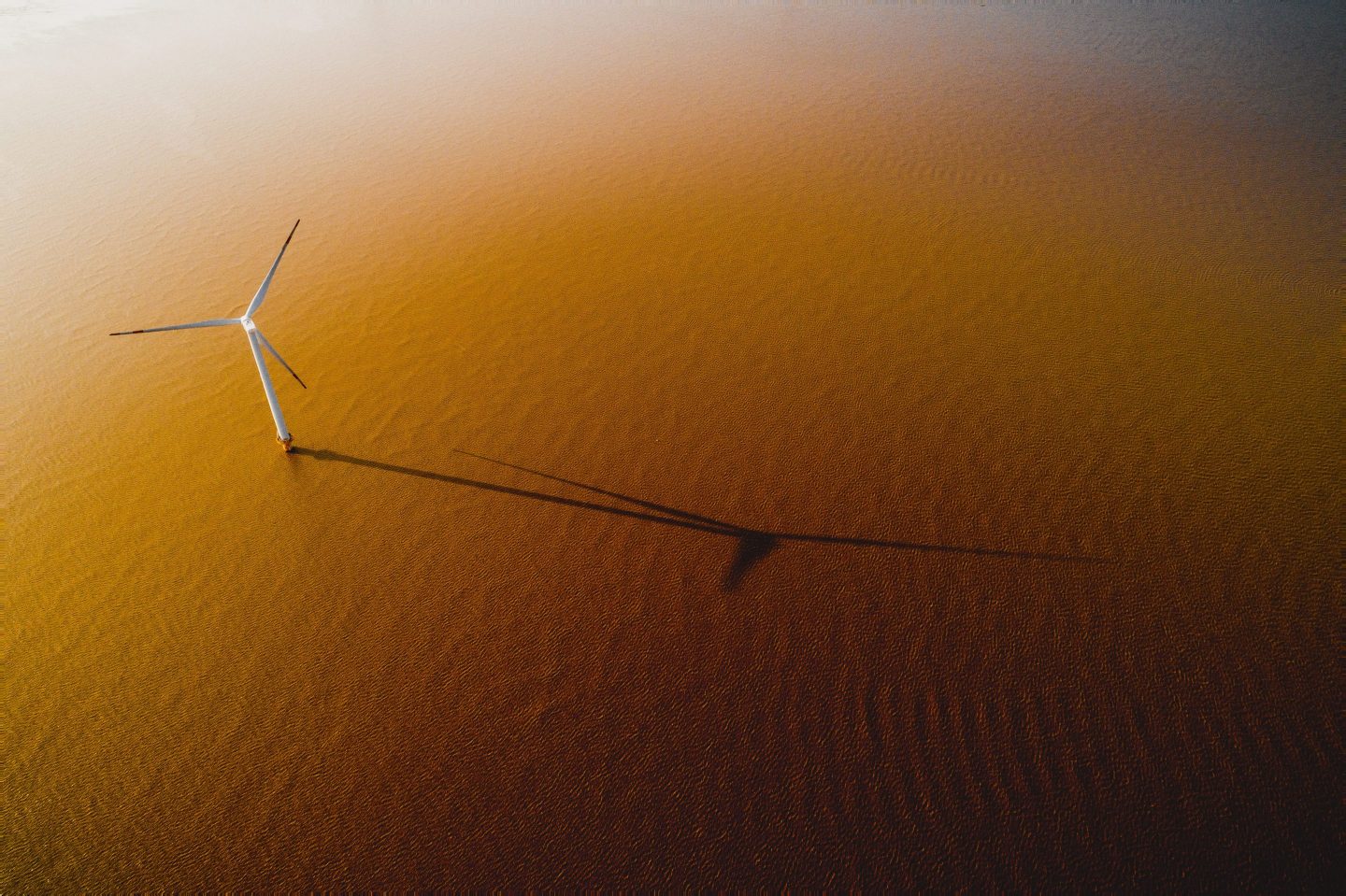 offshore windmill park with stormy clouds and a blue sky, windmill park in the ocean