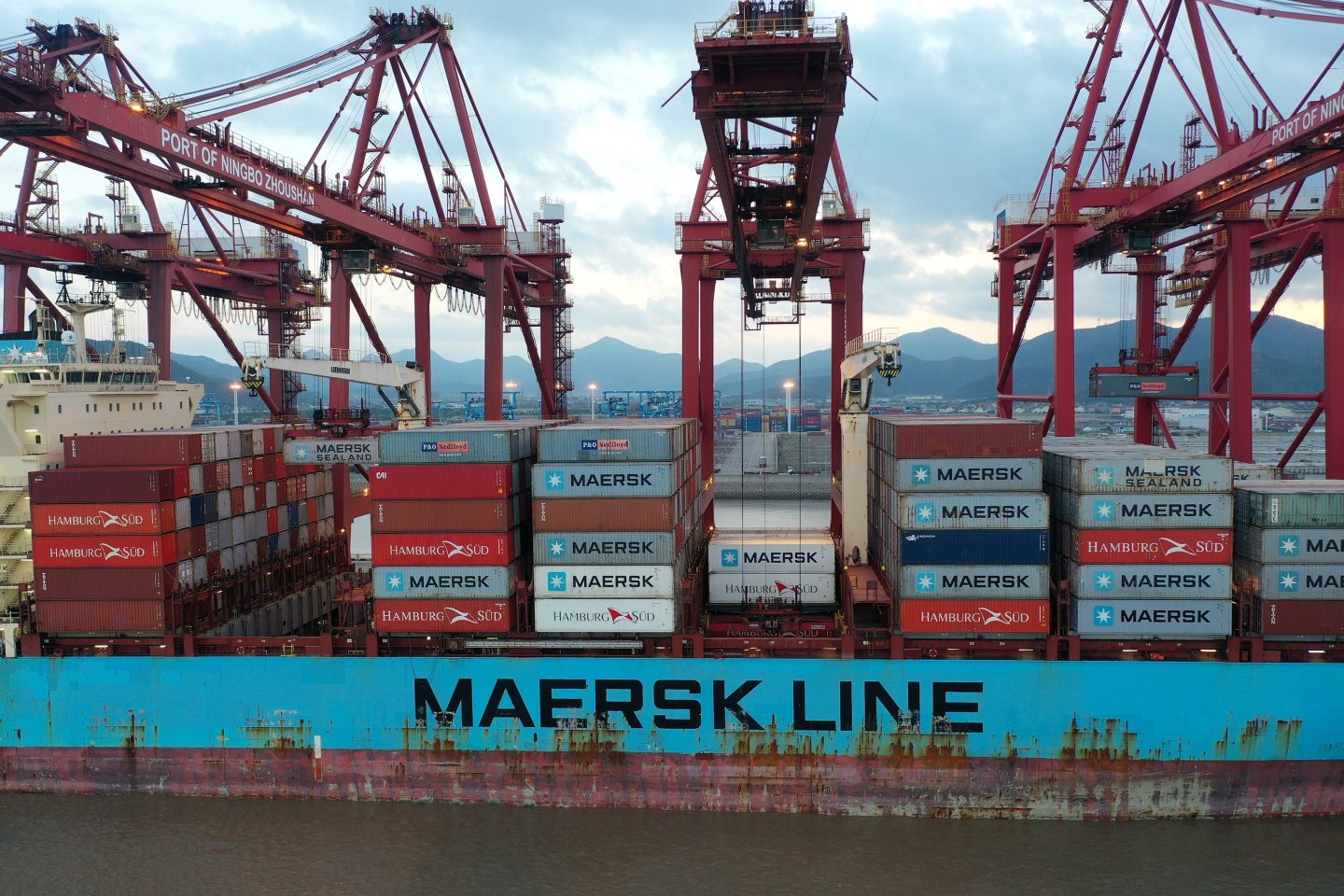 Containers are unloaded from a cargo ship of Maersk Line at Zhoushan port on Oct. 4, 2021, in China.