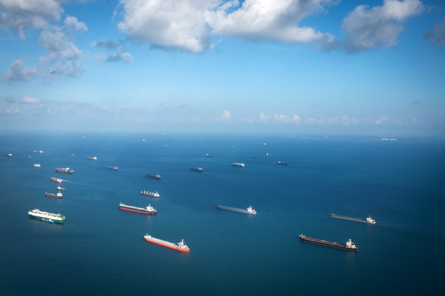 Singapore, Singapore: Transportation and Container ships wait on the ocean in front of the port of Singapore.