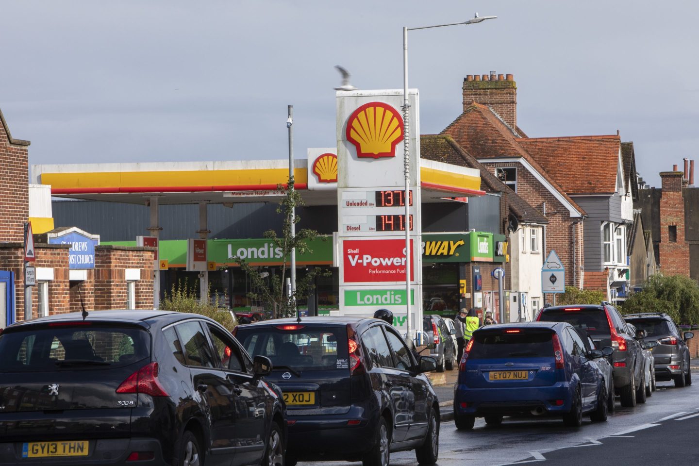 Cars waiting in a line to fill up at a Shell Station in Southern England amid the country's recent gas shortages.