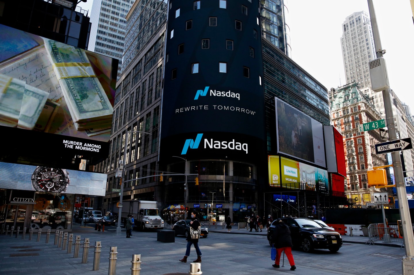 NEW YORK, NEW YORK &#8211; MARCH 10: People walk around Nasdaq building at Times Square on March 10, 2021, in New York. The Nasdaq Composite continued falling more than half a percent during the day. Also, the move away from Apple Inc, Amazon.com Inc , Facebook Inc, Tesla Inc and Microsoft Corp, falling during the day, helped small-cap stocks rise more than double the gains of the S&amp;P 500. (Photo by John Smith/VIEWpress)