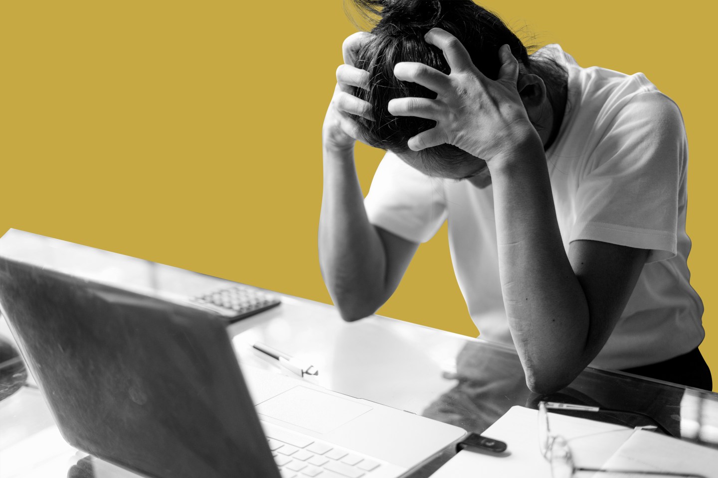 Person at a computer with hands on head