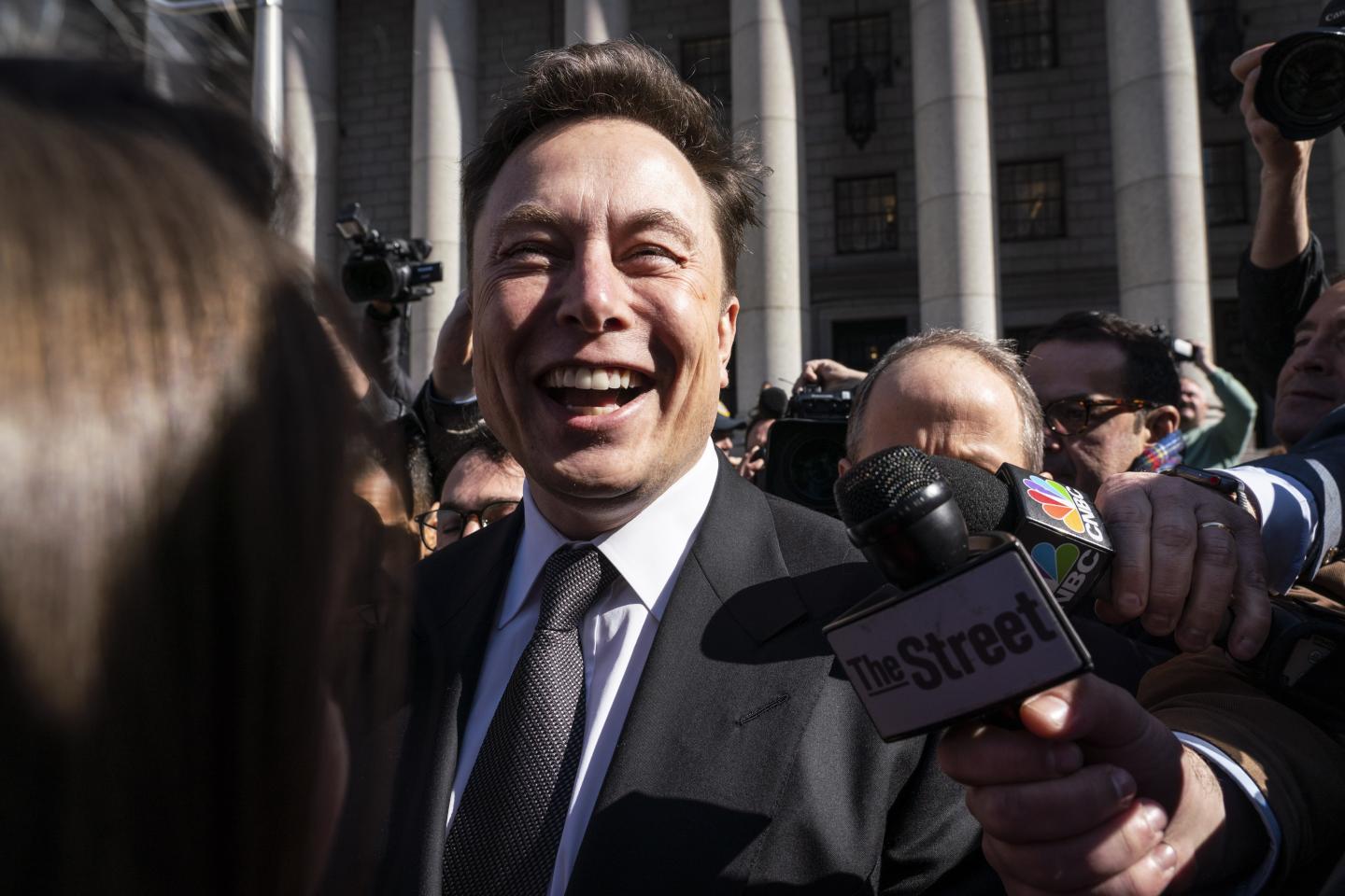 Elon Musk, chief executive officer of Tesla Inc., smiles while speaking to members of the media outside federal court in New York, U.S., on Thursday, April 4, 2019.
