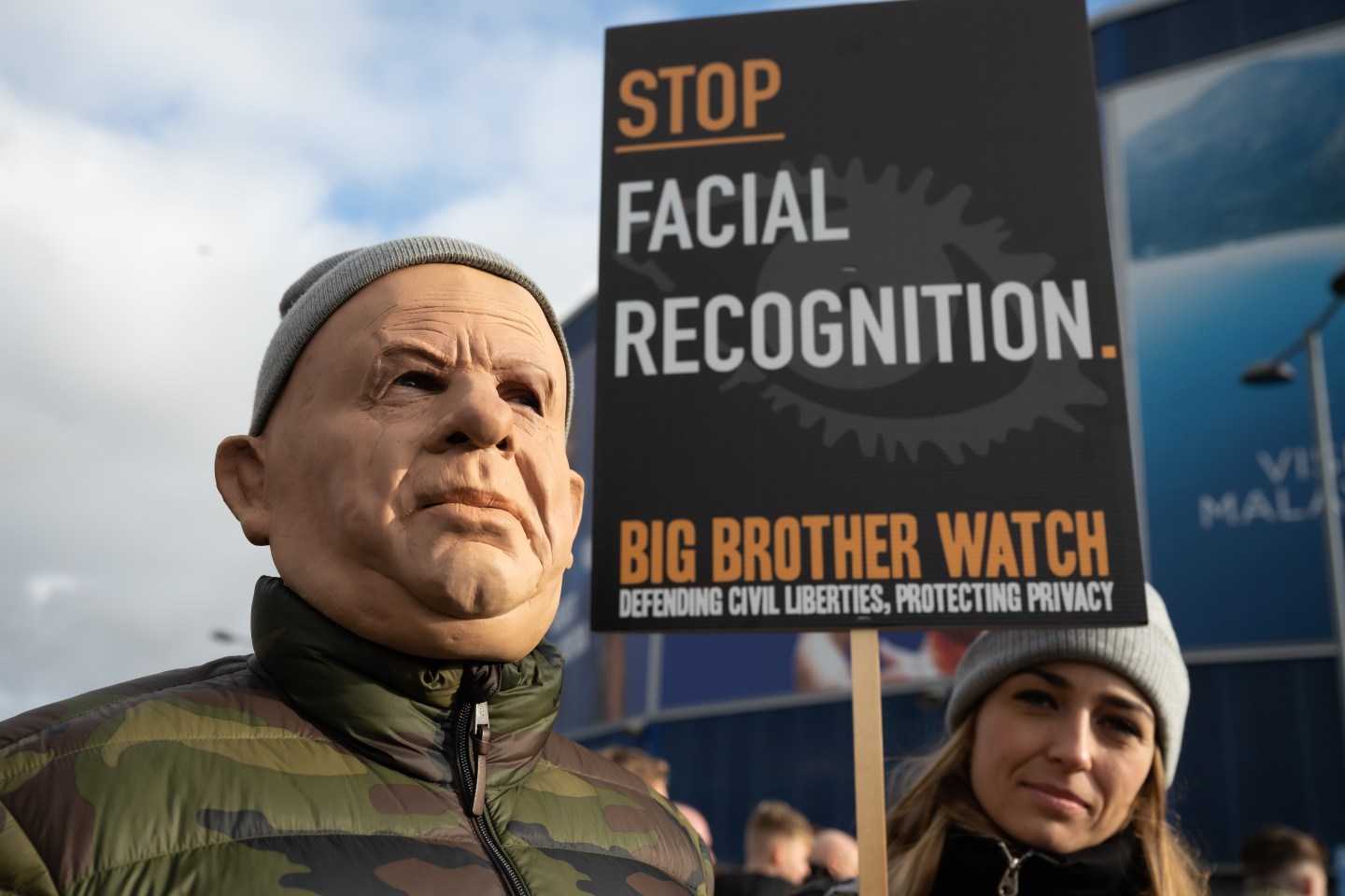 A man in a mask attends a protest against the use of police facial recognition cameras at the Cardiff City Stadium for the Cardiff City v Swansea City Championship match on January 12, 2020 in Cardiff, Wales.