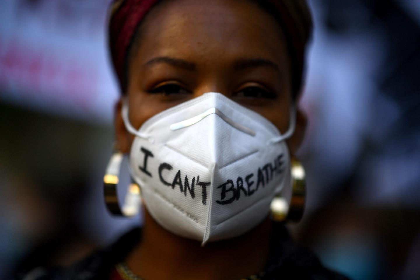 A woman wears a mask reading "I can´t breathe" in Madrid, on June 7, 2020
