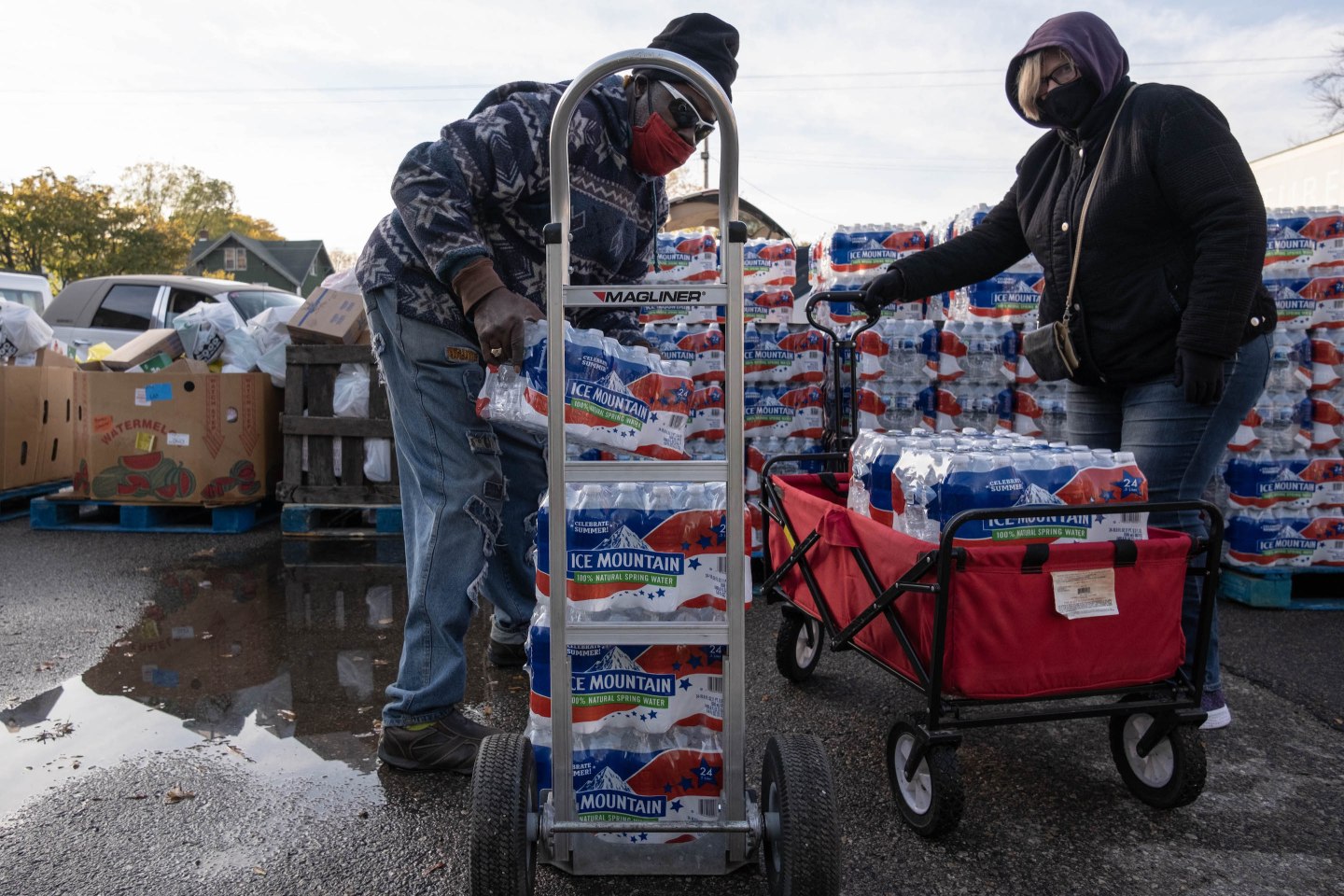 Photo of Flint residents transporting bottled water