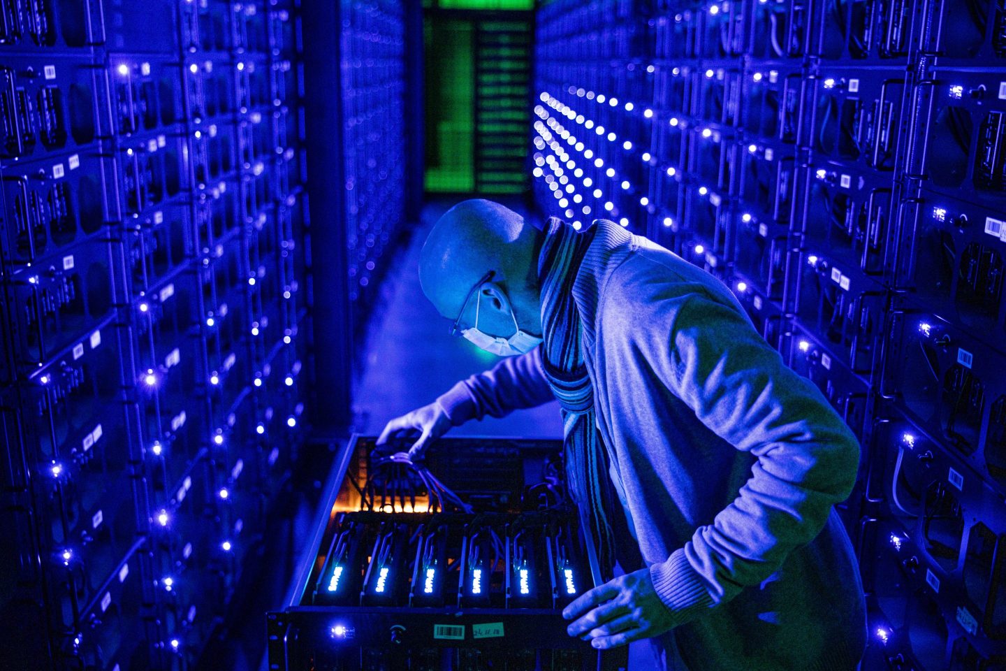 An employee inspects the hardware at the Evobits crypto farm in Cluj-Napoca, Romania. Regulators in Sweden are urging the European Union to ban all Bitcoin mining in the 27-nation bloc.