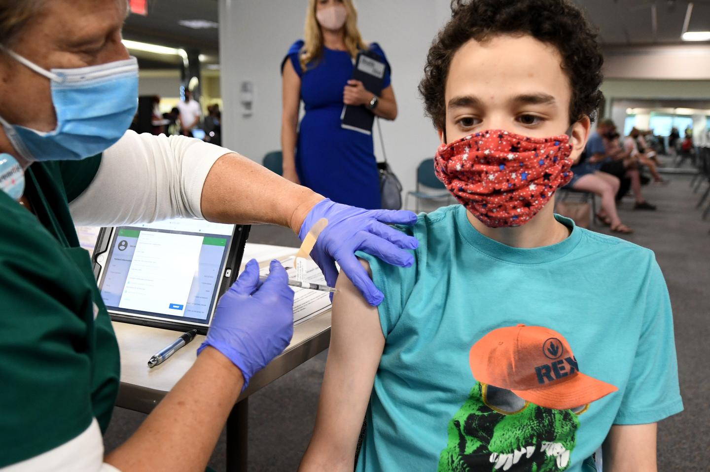 A teenager getting a vaccine shot.