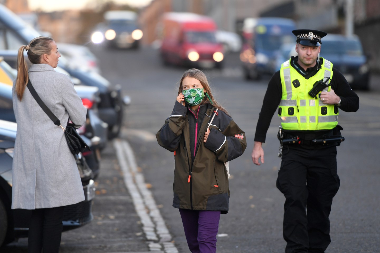 Climate activist Greta Thunberg takes a phone call as she walks to the SWG3 Hub during the COP26 Summit on November 03, 2021 in Glasgow, United Kingdom.