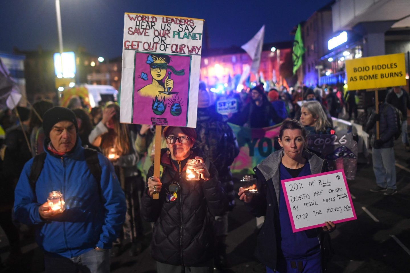 Protesters during an Extinction Rebellion candlelight vigil on Nov. 10, 2021, in Glasgow. “Climate commitments, no matter how well intentioned, mean nothing unless the impacts and emissions are tracked by a transparent and accurate system,” writes Gregor Robertson.