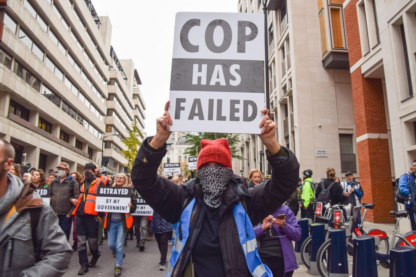 A protester holds a 'COP Has Failed' placard, in reference to the COP26 climate change conference, during the Insulate Britain demonstration in central London.