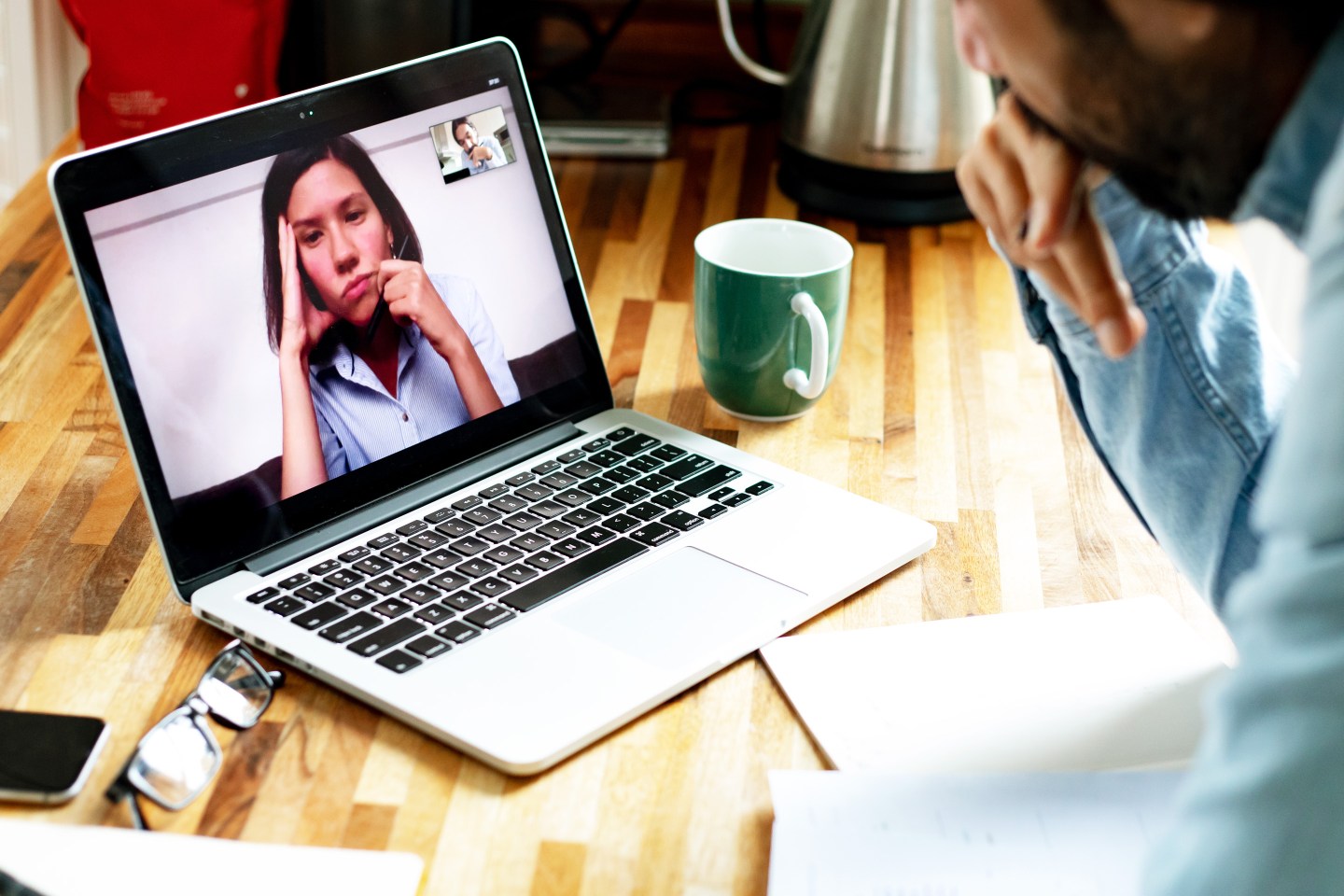 a woman on a computer screen looking bored