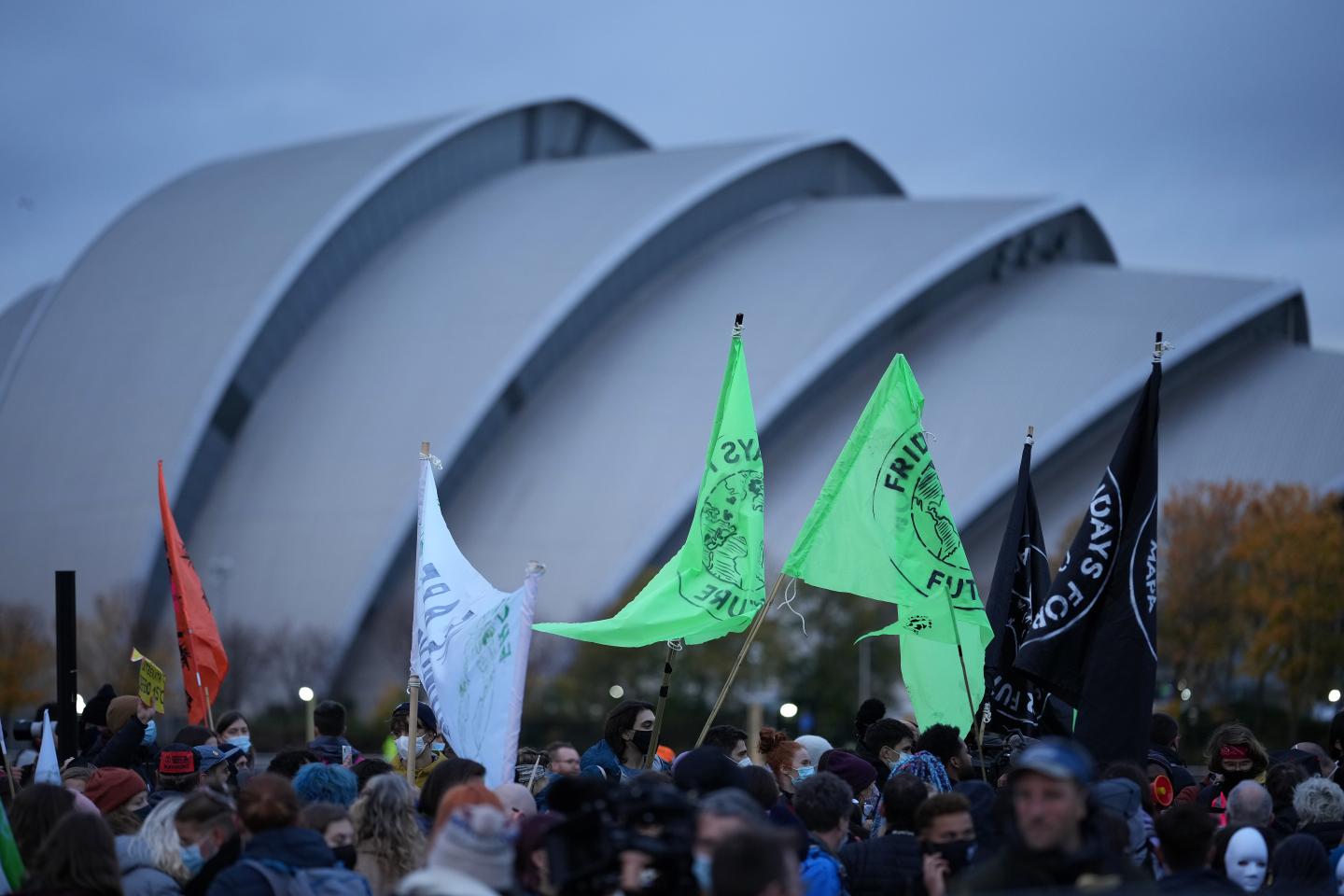 At global climate summit, world leaders cajole while a tattered sign signals doom
