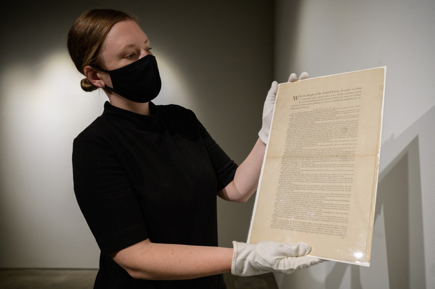 Photo of woman holding copy of U.S. Constitution